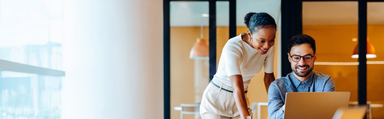Employee with glasses looking at laptop