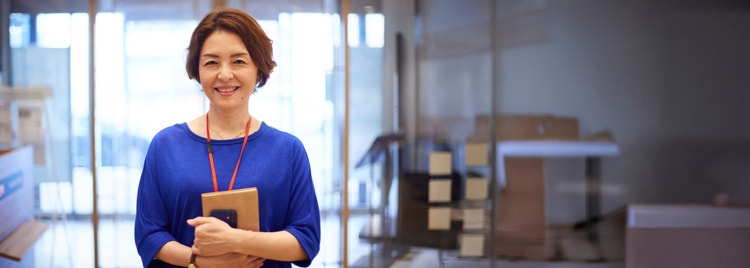 people in a meeting looking at laptop