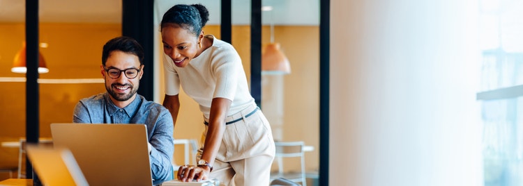 Employee with glasses looking at laptop
