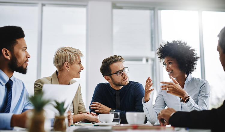 Group of people talking to smiling lady for financial well being