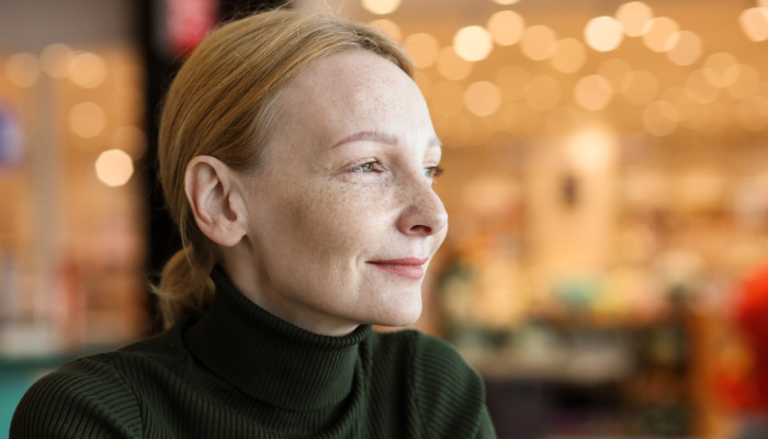 A woman having an interesting discussion with a man in the office.