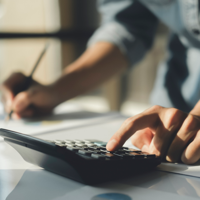 A man using a calculator. How to calculate your novated lease savings? You can use our novated lease calculators.