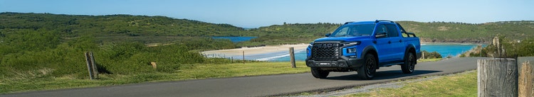 JAC T9 exterior front view on a hill road available on a novated lease in Australia through Maxxia.