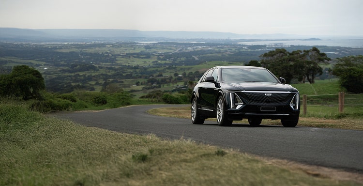 Cadillac LYRIQ exterior front view on a hill road available on a novated lease in Australia through Maxxia.