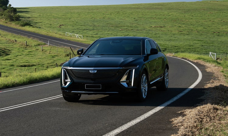 CADILLAC LYRIQ exterior front view on a hill road available on a novated lease in Australia through Maxxia.