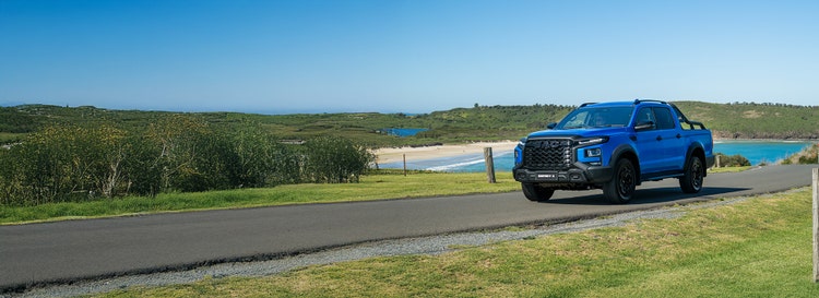 JAC T9 exterior front view on a hill road available on a novated lease in Australia through Maxxia.