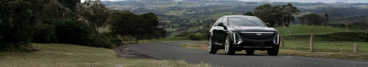 Cadillac LYRIQ exterior front view on a hill road available on a novated lease in Australia through Maxxia.