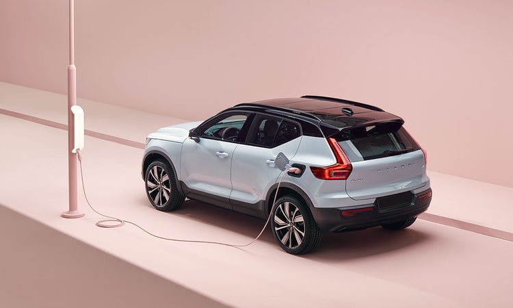 Volvo XC40 read exterior view charging on the street available for a novated lease in Australia with Maxxia.