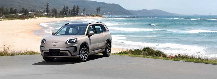 GAC AION exterior front view on a hill road available on a novated lease in Australia through Maxxia.