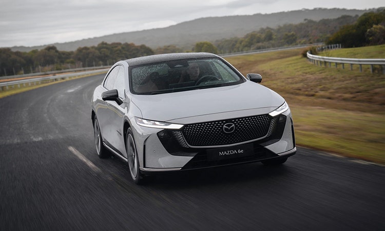 Mazda 6e on a highway available for a novated lease through Maxxia