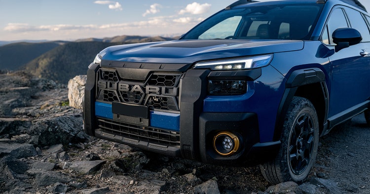 Subaru Outback front exterior view in front of a building. Contact Maxxia for Subaru Outback novated lease today.