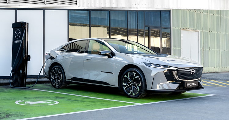 Mazda 6e front exterior view in front of Mazda showroom on recharge, novate an Mazda 6e through Maxxia. Contact Maxxia novated leasing team today.