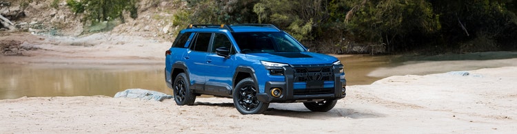 Subaru Outback front exterior view in front of a building. Contact Maxxia for Subaru Outback novated lease today.
