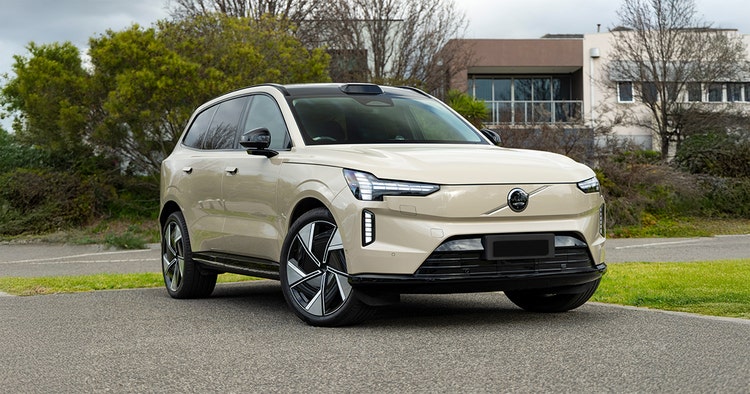 Volvo EX90 exterior front view on a highway. Contact Maxxia for Volvo EX90 novated lease today.