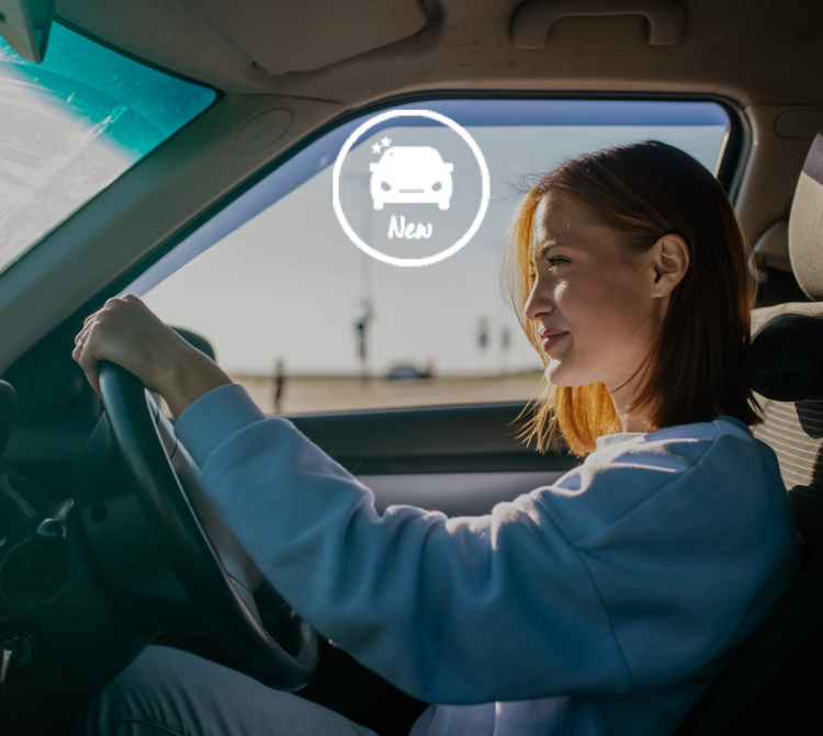 A woman smiling driving her new car. How to get a great new car deals? Maxxia has access to Australia's dealership network.
