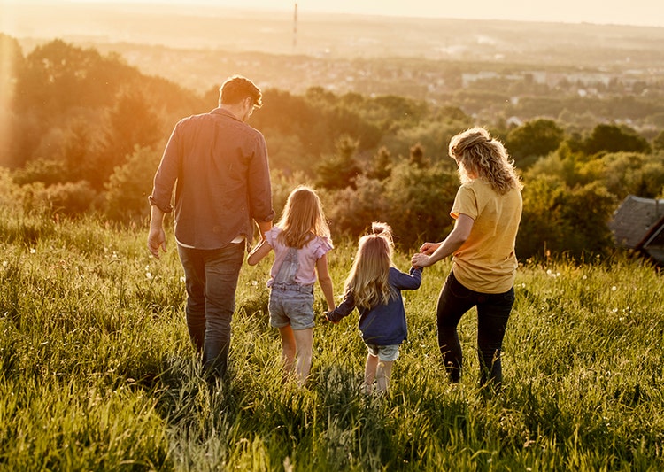 A family out in the grassy woodland. Learn how you could use part of pre-tax earnings to save on tax with salary packaging.