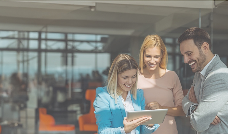 employees looking at a laptop