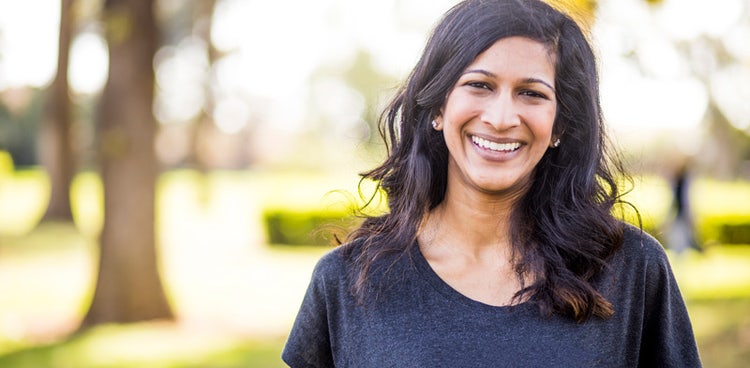 A charity worker smiling happy to learn about salary sacrifice for charity sector employees available with Maxxia.