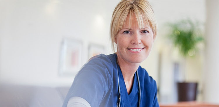A nurse smiling happy to learn about salary sacrifice for health sector employees available with Maxxia.
