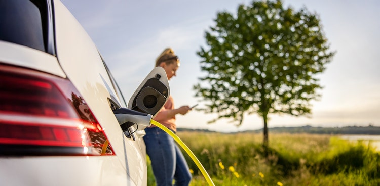 An electric car charging on the street