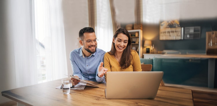 Maxxia novated leasing staff smiling looking straight at you while holding a paper.