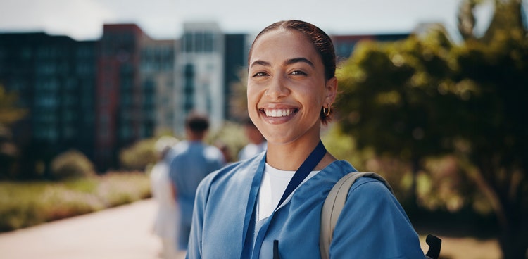 Maxxia novated leasing staff smiling looking straight at you while holding a paper.