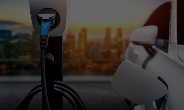 An EV at charging station. Try out our electric vehicles novated lease calculator to estimate how much tax you could save.
