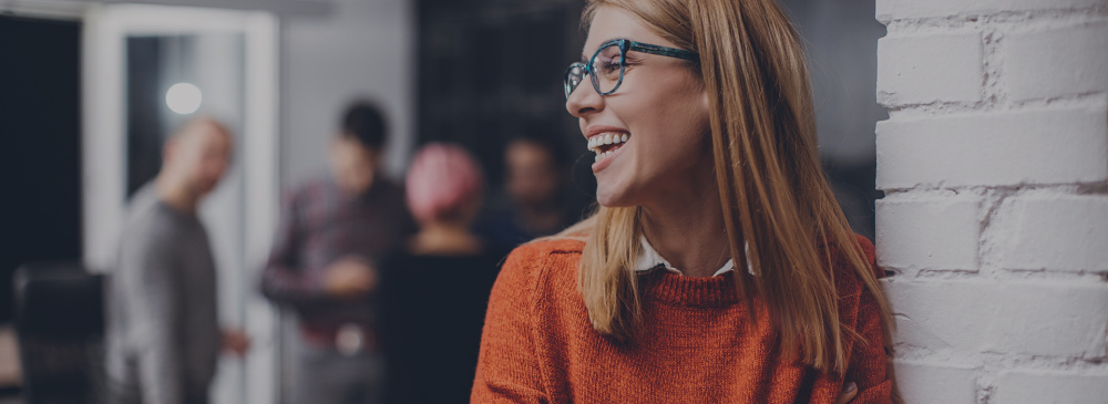 A woman laughing in the office.