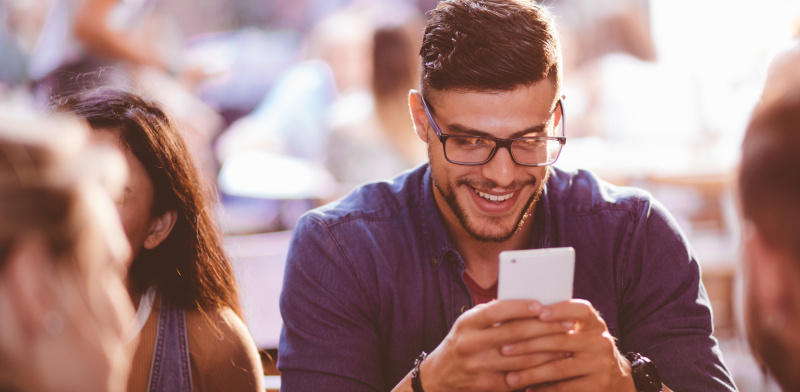 Man smiling at phone