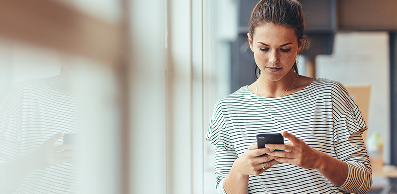 Woman managing account on mobile device