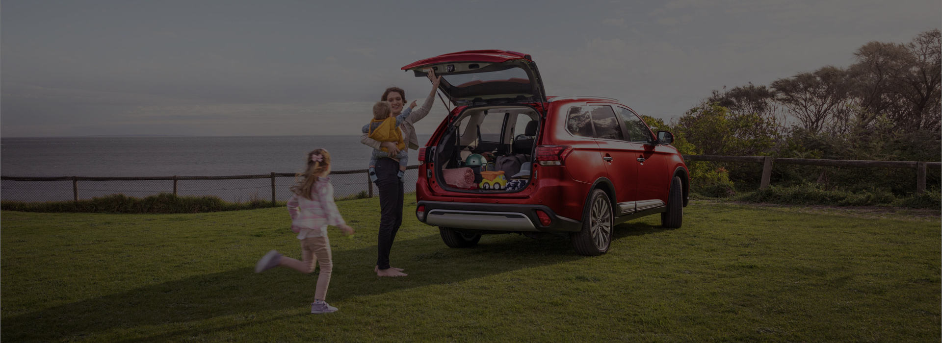 Mum and daughter near red car