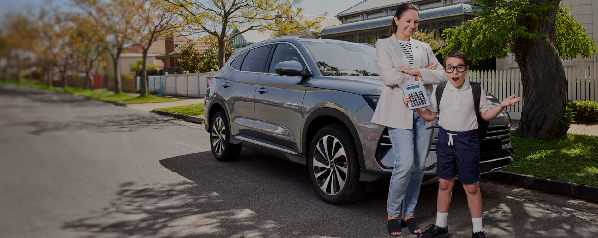 A kid holding a calculator surprised in front of his mother and their car - MaxxiaLeasing