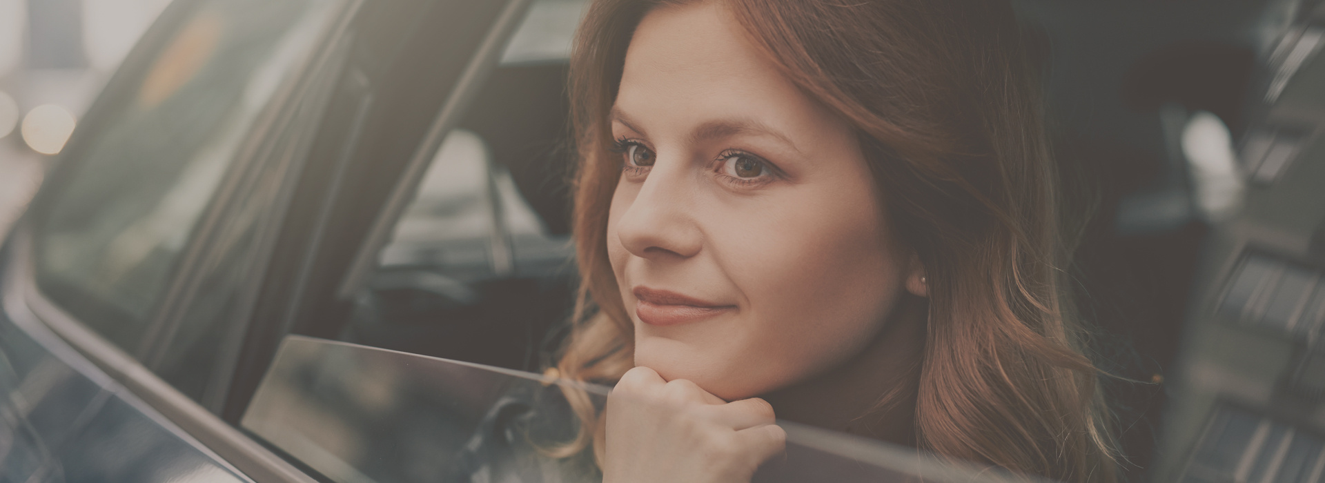 Woman looking out a car window