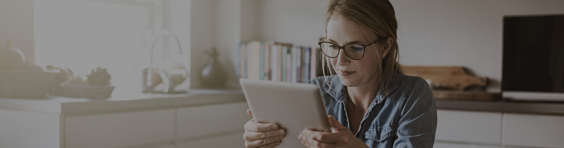 A woman staring at her IPad.