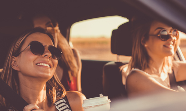 Best friends having a great time on a car trip.