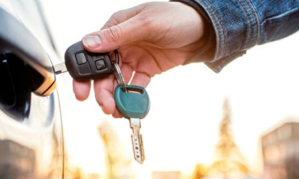 Car door with keys in hand.