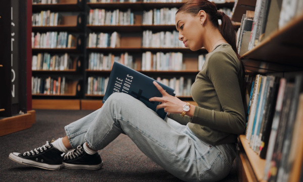 HECS a student in a library