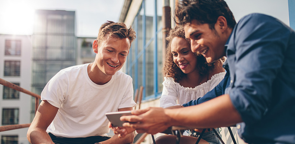 Group of friends looking at content on mobile device